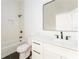 Cozy bathroom with tub-shower combo, modern vanity, black hardware, and hexagon tile floor, offering a clean aesthetic at 156 Martha Ne Ave, Atlanta, GA 30317