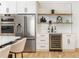 Kitchen area featuring stainless steel refrigerator, built-in ovens, and custom cabinets at 156 Martha Ne Ave, Atlanta, GA 30317