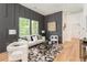 Stylish living room with textured gray wall, modern decor, and ample natural light at 156 Martha Ne Ave, Atlanta, GA 30317