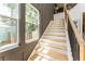 Bright staircase with wood steps, gray walls, black railing, and modern design at 156 Martha Ne Ave, Atlanta, GA 30317