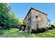 Exterior view of a brick home with a wooden deck overlooking the backyard at 1652 Park Hollow Ln, Lawrenceville, GA 30043