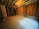 Unfinished basement area offering great potential, with concrete floors and exposed wooden beams, ready for personalization at 1652 Park Hollow Ln, Lawrenceville, GA 30043