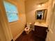 Powder room featuring a sink, toilet, natural light and hard wood floors at 1652 Park Hollow Ln, Lawrenceville, GA 30043