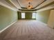 Spacious main bedroom with trey ceiling, carpet flooring, and natural light at 1652 Park Hollow Ln, Lawrenceville, GA 30043