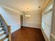 Elegant dining room with crown molding, hardwood floors, and a modern chandelier at 1652 Park Hollow Ln, Lawrenceville, GA 30043