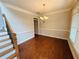 Elegant dining room with crown molding, hardwood floors, and a modern chandelier at 1652 Park Hollow Ln, Lawrenceville, GA 30043