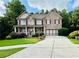 Charming two-story brick home with a manicured lawn and a spacious driveway at 1652 Park Hollow Ln, Lawrenceville, GA 30043