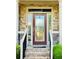 Elegant front door with decorative glass panels, stone accents, and a welcoming entrance at 1652 Park Hollow Ln, Lawrenceville, GA 30043