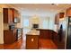 Modern kitchen with stainless appliances, granite countertops, tile backsplash, hardwood floors, and an island at 1652 Park Hollow Ln, Lawrenceville, GA 30043
