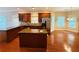 Kitchen featuring stainless steel appliances, granite countertops, hardwood flooring, and a central island at 1652 Park Hollow Ln, Lawrenceville, GA 30043