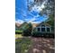 Exterior shot of house showcasing mature landscaping, large window, and peaceful setting, creating an inviting outdoor space at 3836 Vineyards Lake Nw Cir # U17, Kennesaw, GA 30144