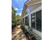 Siding of home featuring large windows, and potted plants, ideal for enjoying natural light and greenery at 3836 Vineyards Lake Nw Cir # U17, Kennesaw, GA 30144