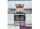 Kitchen range with white cabinets and stainless steel appliances at 3836 Vineyards Lake Nw Cir # U17, Kennesaw, GA 30144