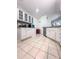 Bright kitchen with white cabinets, granite countertops and tile flooring at 3836 Vineyards Lake Nw Cir # U17, Kennesaw, GA 30144