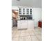 Bright kitchen with white cabinets, granite countertops, glass cupboards and tile flooring at 3836 Vineyards Lake Nw Cir # U17, Kennesaw, GA 30144