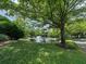 Scenic pond with a fountain surrounded by well-manicured landscaping and mature trees at 3836 Vineyards Lake Nw Cir # U17, Kennesaw, GA 30144