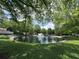 Pond with a water fountain, surrounded by landscaping and mature trees at 3836 Vineyards Lake Nw Cir # U17, Kennesaw, GA 30144