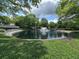 Scenic pond with a fountain, surrounded by lush greenery, offering a tranquil and picturesque community space at 3836 Vineyards Lake Nw Cir # U17, Kennesaw, GA 30144