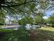 Community pond with fountain surrounded by mature trees and greenery at 3836 Vineyards Lake Nw Cir # U17, Kennesaw, GA 30144