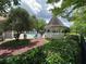 Relaxing community pool area featuring a gazebo, lounge chairs, and meticulous landscaping, for luxurious outdoor enjoyment at 3836 Vineyards Lake Nw Cir # U17, Kennesaw, GA 30144