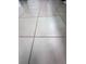 Close-up of the neutral-toned tile flooring with dark grout throughout the home at 3836 Vineyards Lake Nw Cir # U17, Kennesaw, GA 30144