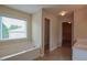 Bright bathroom featuring a soaking tub, window with blinds, and access to the closet and toilet at 4032 Duran Ln, Auburn, GA 30011