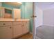 Bathroom vanity with blue walls, mirror, and cabinets, next to a bedroom at 4032 Duran Ln, Auburn, GA 30011