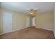 Neutral bedroom featuring a ceiling fan, and multiple doorways to other rooms at 4032 Duran Ln, Auburn, GA 30011