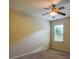 Cozy bedroom featuring a ceiling fan and a window for natural light at 4032 Duran Ln, Auburn, GA 30011