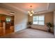 Dining room featuring decorative molding and hardwood floors, with a view of the kitchen at 4032 Duran Ln, Auburn, GA 30011