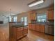 Modern kitchen with stainless steel appliances, hardwood floors, and breakfast bar overlooking the living room at 4032 Duran Ln, Auburn, GA 30011