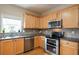 Kitchen with stainless steel appliances, double oven, hardwood floors, and window above sink at 4032 Duran Ln, Auburn, GA 30011