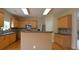 Bright kitchen features stainless steel appliances, wood cabinets, and stone countertops at 4032 Duran Ln, Auburn, GA 30011