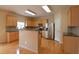 Bright kitchen features stainless steel appliances, wood cabinets, and stone countertops at 4032 Duran Ln, Auburn, GA 30011