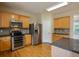 Open kitchen with stainless steel appliances, hardwood floors, and recessed lighting at 4032 Duran Ln, Auburn, GA 30011