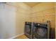 Laundry room with updated washer and dryer and wire shelving at 4032 Duran Ln, Auburn, GA 30011
