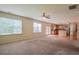 Spacious living room with natural light and ceiling fan flowing into adjacent kitchen at 4032 Duran Ln, Auburn, GA 30011