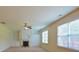 Cozy living room featuring a fireplace, built-in shelving, and large windows for plenty of natural light at 4032 Duran Ln, Auburn, GA 30011