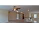 Open loft with lots of neutral carpeting and a view of the ceiling fan at 4032 Duran Ln, Auburn, GA 30011