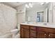 Bathroom with double sink vanity and shower with patterned curtain at 8215 Harlond Way, Suwanee, GA 30024