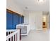 Bedroom with two cribs and a blue accent wall at 8215 Harlond Way, Suwanee, GA 30024