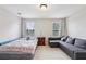 Bedroom with bed, sofa, and two large windows at 8215 Harlond Way, Suwanee, GA 30024