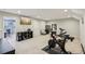 Large bonus room with gym equipment, storage, and view of home office at 8215 Harlond Way, Suwanee, GA 30024
