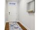 Bright entryway with hardwood floors, a stylish rug, and modern decor at 8215 Harlond Way, Suwanee, GA 30024