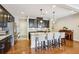 Spacious kitchen features dark cabinetry, granite countertops, stainless steel appliances and large center island at 8215 Harlond Way, Suwanee, GA 30024