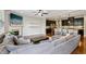 Open concept living room featuring a fireplace and seamless connection to the modern kitchen at 8215 Harlond Way, Suwanee, GA 30024
