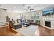 Open living room features hardwood floors, fireplace, and a large sectional sofa for relaxation at 8215 Harlond Way, Suwanee, GA 30024
