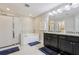Elegant main bathroom featuring a soaking tub, a glass shower, and double sinks at 8215 Harlond Way, Suwanee, GA 30024