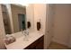 Bathroom features a white sink, wood vanity, and a mirror with vanity lighting at 1000 Silver Summit Se Dr, Conyers, GA 30094