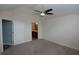 Spacious bedroom featuring vaulted ceiling, neutral carpet, ceiling fan, and an attached bathroom entrance at 1000 Silver Summit Se Dr, Conyers, GA 30094